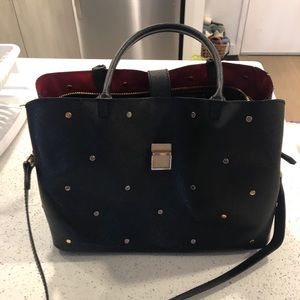 Studded black faux leather handbag